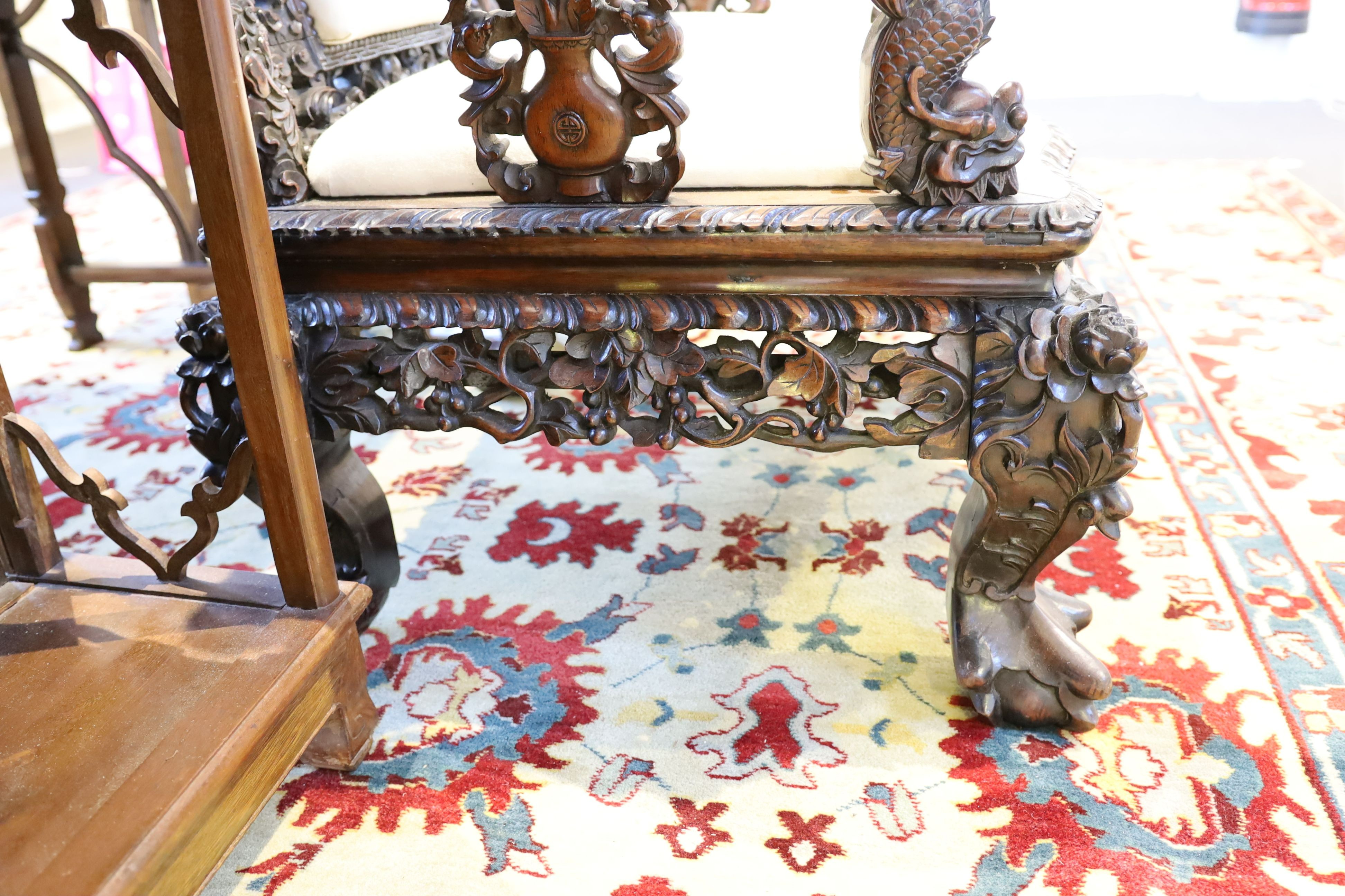 A good Chinese hardwood ‘dragon’ throne armchair, c.1900, 114.5cm high, 68cm wide at the arms